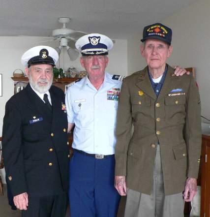 Coast Guard Auxiliarist and author, Brian McMahon, poses in between retired BMCM Maurice Poulin (left) and World War II veteran Charles Cossaboom. (Courtesy of the author) Coast Guard Auxiliarist and author, Brian McMahon, poses in between retired BMCM Maurice Poulin (left) and World War II veteran Charles Cossaboom. (Courtesy of the author)